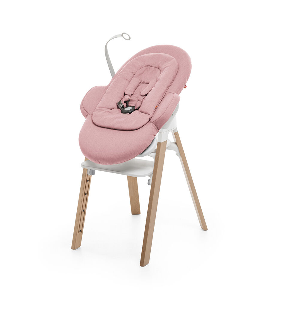 Bouncer, Pink. Mounted on Stokke Steps highchair.